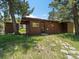 Rustic shed in a natural setting, surrounded by trees and greenery at 31756 Buffalo Park Rd, Evergreen, CO 80439