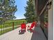 Outdoor patio space with red Adirondack chairs, perfect for outdoor dining and enjoying the mountain view at 31756 Buffalo Park Rd, Evergreen, CO 80439
