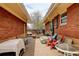 Backyard patio with seating and brick exterior, creating a cozy and inviting outdoor space at 345 Central Ave, Brighton, CO 80601