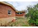 Outdoor space with a partial view of the home, featuring a brick exterior and landscaping at 345 Central Ave, Brighton, CO 80601