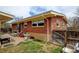 Exterior view of the backyard featuring brick details and patio seating area, and wood fence at 345 Central Ave, Brighton, CO 80601