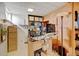 Basement office with a built in shelf, storage, desk, office chair and window at 345 Central Ave, Brighton, CO 80601