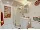 Bathroom features a glass enclosed shower, white vanity, tiled floor, and wall art at 345 Central Ave, Brighton, CO 80601