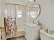 Bright bathroom featuring tile surround shower, vanity, mirror, and white tiled walls at 345 Central Ave, Brighton, CO 80601