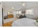 Bedroom features hardwood floors, ceiling fan, two windows with curtains and vintage furnishings at 345 Central Ave, Brighton, CO 80601