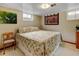 Basement bedroom with floral bedding, an accent chair, and a small window at 345 Central Ave, Brighton, CO 80601