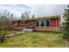 Charming home with a well-maintained lawn and colorful garden beds, creating excellent curb appeal at 345 Central Ave, Brighton, CO 80601