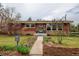Charming brick home with a manicured front yard and inviting walkway at 345 Central Ave, Brighton, CO 80601