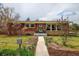 Charming brick home with a manicured front yard and inviting walkway at 345 Central Ave, Brighton, CO 80601