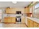 Bright kitchen with wooden cabinets and tile backsplash at 345 Central Ave, Brighton, CO 80601