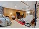 Cozy living room with wood paneling, comfortable seating, and entertainment center for a relaxing atmosphere at 345 Central Ave, Brighton, CO 80601