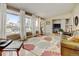 Open living room featuring hardwood floors, large windows, and a comfortable seating area at 345 Central Ave, Brighton, CO 80601