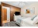 Bedroom featuring paneled wall, ceiling fan, carpet, and a small television at 7131 Raritan St, Denver, CO 80221