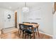 Cozy dining area featuring hardwood floors, a modern light fixture, and a window at 7131 Raritan St, Denver, CO 80221