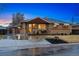 Inviting brick house featuring an attached garage and a cozy front porch at 7131 Raritan St, Denver, CO 80221