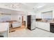 Bright kitchen with white cabinets, stainless steel appliances, and tile flooring at 7131 Raritan St, Denver, CO 80221