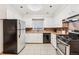 Spacious kitchen featuring white cabinets, tile floors, and stainless steel appliances at 7131 Raritan St, Denver, CO 80221