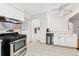 Bright kitchen with stainless steel appliances, tile backsplash, and adjacent dining area at 7131 Raritan St, Denver, CO 80221