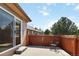 Backyard patio with fence, accessed by sliding glass door, offering relaxing outdoor space at 16141 W 64Th Way, Arvada, CO 80007