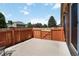 Private backyard with a concrete patio, surrounded by a wood fence, and mature trees at 16141 W 64Th Way, Arvada, CO 80007