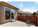 Backyard patio with sliding glass door, fenced, and ready for entertaining at 16141 W 64Th Way, Arvada, CO 80007