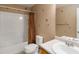 Bathroom with tub-shower combo, single sink vanity, and neutral wall décor at 16141 W 64Th Way, Arvada, CO 80007