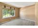 Bedroom featuring a light-blocking shade on a large window and light carpeting at 16141 W 64Th Way, Arvada, CO 80007