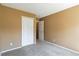 Tan bedroom with an open closet and neutral colored carpeting at 16141 W 64Th Way, Arvada, CO 80007