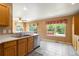 Eat-in kitchen featuring stainless steel appliances, tile flooring, and large windows with garden views at 16141 W 64Th Way, Arvada, CO 80007