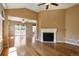 Open living room with hardwood floors, fireplace, and sliding glass door access to back patio at 16141 W 64Th Way, Arvada, CO 80007