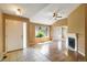 Bright living room with hardwood floors, fireplace, large windows, and vaulted ceilings at 16141 W 64Th Way, Arvada, CO 80007