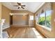Spacious living room featuring hardwood floors, ceiling fan, and ample natural light at 16141 W 64Th Way, Arvada, CO 80007