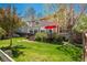 Expansive backyard with lush lawn, patio, and mature trees provides a private retreat for outdoor enjoyment at 19099 E Creekside Dr, Parker, CO 80134