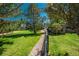 A serene backyard featuring a stone pathway, lush greenery, and a charming playhouse at 19099 E Creekside Dr, Parker, CO 80134