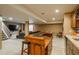 Finished basement area featuring a bar with seating, a TV, and staircase at 19099 E Creekside Dr, Parker, CO 80134