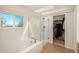 Modern bathroom featuring a glass-enclosed shower, soaking tub, and a walk-in closet at 19099 E Creekside Dr, Parker, CO 80134