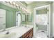 Well-lit bathroom with dual sinks, a large mirror, and a separate toilet room at 19099 E Creekside Dr, Parker, CO 80134