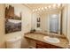 Well-lit bathroom featuring a granite countertop, decorative artwork, and a toilet at 19099 E Creekside Dr, Parker, CO 80134