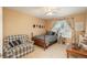 Comfortable bedroom with a cozy armchair, wooden furniture, and ample natural light at 19099 E Creekside Dr, Parker, CO 80134
