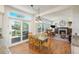 Bright dining area with access to outdoor deck and views of the living area with fireplace, promoting seamless indoor-outdoor living at 19099 E Creekside Dr, Parker, CO 80134