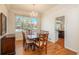 Traditional dining room features hardwood floors, a modern chandelier, and a large window overlooking the yard at 19099 E Creekside Dr, Parker, CO 80134