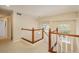 Upstairs hallway with wood trim and window at 19099 E Creekside Dr, Parker, CO 80134