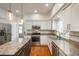 Well-lit kitchen boasting stainless steel appliances, an island, and granite countertops, perfectly blending style and functionality at 19099 E Creekside Dr, Parker, CO 80134