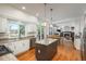 Bright, open kitchen featuring an island, granite countertops, stainless steel appliances, and a seamless flow into the living area at 19099 E Creekside Dr, Parker, CO 80134