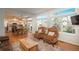 Bright living space flowing into the kitchen and dining area with large windows and hardwood floors, offers open-concept living at 19099 E Creekside Dr, Parker, CO 80134