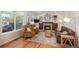 Cozy living room featuring hardwood floors, a stone fireplace, and built-in shelving, creating an inviting and comfortable space at 19099 E Creekside Dr, Parker, CO 80134