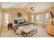 Bright and spacious main bedroom boasts a vaulted ceiling, ample windows, and a comfortable sitting area at 19099 E Creekside Dr, Parker, CO 80134