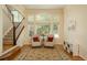 Bright sitting room featuring hardwood floors, an area rug, and oversized windows offering plenty of natural light at 19099 E Creekside Dr, Parker, CO 80134