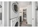 Convenient laundry area with stackable washer and dryer near a well-lit, updated bathroom at 2005 S Helena St # G, Aurora, CO 80013