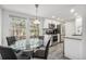 Eat-in kitchen features granite countertops, stainless steel appliances, and a view into the front yard at 2005 S Helena St # G, Aurora, CO 80013